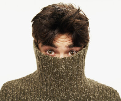 A Man in a Sweater Wonders If He is At Risk of Developing Psoriasis