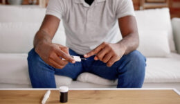 African American Man Testing Blood Sugar Level Maintenance