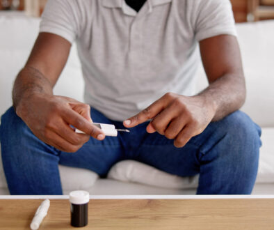 African American Man Testing Blood Sugar Level Maintenance