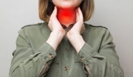 A Woman Holding Her Throat With A Red Highlight Showing Her Thyroid Glands Thyroid Eye Disease