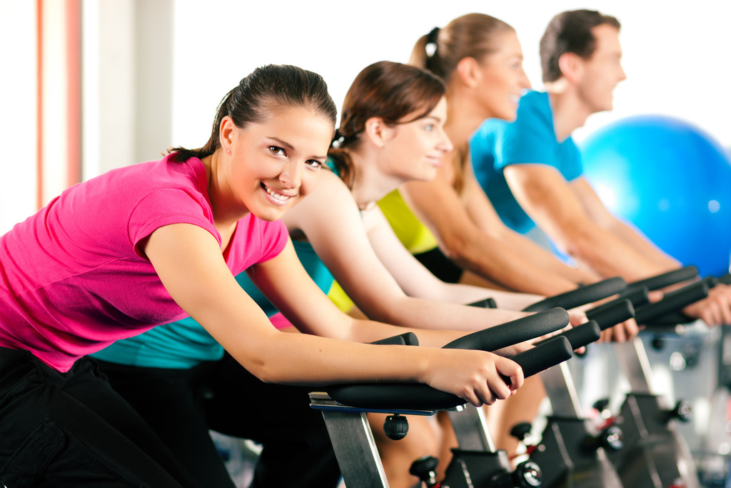 A Group Exercising On Bicyles