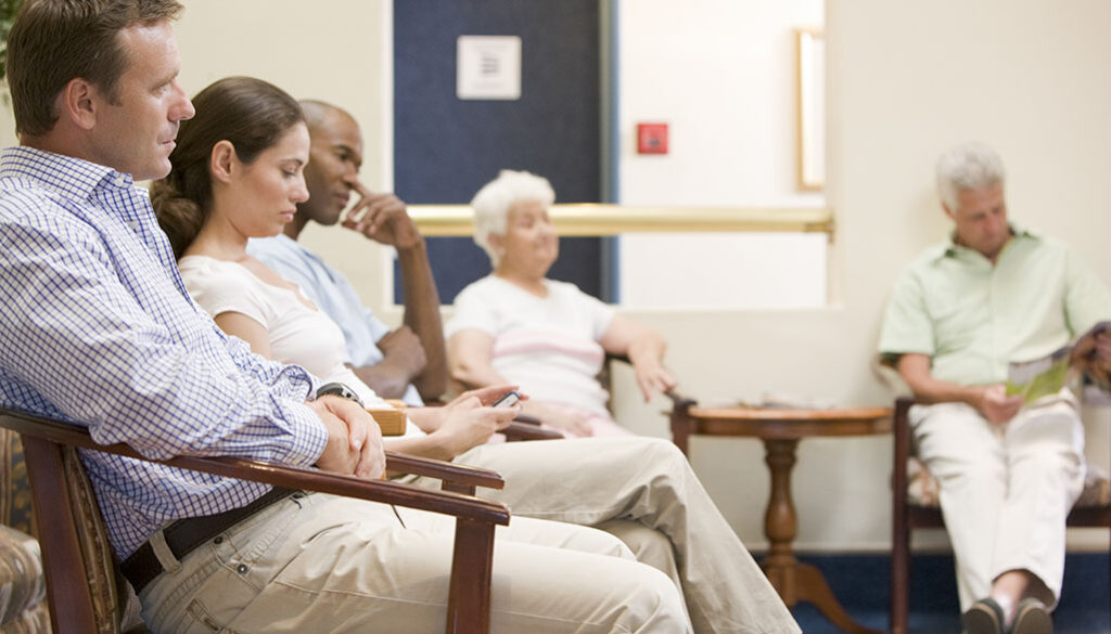 Five People Sitting in a Doctor’s Office Waiting Room Waiting to See the Doctor Why Do Doctors Take So Long